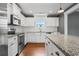 Updated white kitchen with stainless steel appliances and granite countertops at 250 Penn Circle, Galivants Ferry, SC 29544