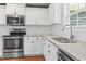 Close-up of modern kitchen with stainless steel appliances and granite countertops at 250 Penn Circle, Galivants Ferry, SC 29544