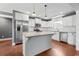 Modern white kitchen with stainless steel appliances, granite countertops, and central island at 250 Penn Circle, Galivants Ferry, SC 29544