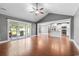 Open concept living area with hardwood floors leading to modern kitchen with stainless appliances and outdoor patio at 250 Penn Circle, Galivants Ferry, SC 29544