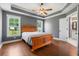 Large bedroom with wood floors, tray ceilings, and view of ensuite bathroom at 250 Penn Circle, Galivants Ferry, SC 29544
