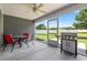 Covered patio with ceiling fan, grill, and screened enclosure at 250 Penn Circle, Galivants Ferry, SC 29544