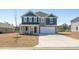 Charming two-story home featuring a gray exterior, two-car garage, and a well-manicured lawn at 28 Cape Point Dr., Conway, SC 29527
