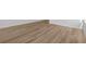 Close up of modern, neutral-colored wood-look flooring with white trim at 28 Cape Point Dr., Conway, SC 29527