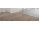 Neutral carpeted hallway featuring white walls and baseboards, perfect transition between rooms at 28 Cape Point Dr., Conway, SC 29527