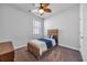 Bright bedroom features neutral carpeting, a ceiling fan, and a simple wooden bed frame at 2882 Ophelia Way, Myrtle Beach, SC 29577