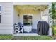A cozy covered patio features string lights, outdoor seating, a grill, and sliding glass doors to the home's interior at 2882 Ophelia Way, Myrtle Beach, SC 29577