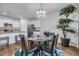 Bright dining area with modern lighting, a glass table set and a view into the kitchen at 2882 Ophelia Way, Myrtle Beach, SC 29577