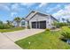 This home features a well-manicured lawn, landscaping and a two-car garage at 2882 Ophelia Way, Myrtle Beach, SC 29577
