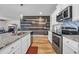 Spacious kitchen with granite countertops, stainless appliances, breakfast bar, and a stylish wood accent wall at 2882 Ophelia Way, Myrtle Beach, SC 29577