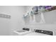 Bright laundry room equipped with modern washer and dryer, shelving and ample storage space at 2882 Ophelia Way, Myrtle Beach, SC 29577