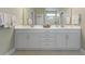 Bathroom featuring double sinks and a large white cabinet for ample storage at 308 Firenze Loop, Myrtle Beach, SC 29579