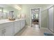 Bathroom featuring double sinks and a large white cabinet with access to the main bedroom at 308 Firenze Loop, Myrtle Beach, SC 29579