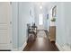 Bright entryway boasts hardwood floors, light-blue walls, and a charming accent chair at 308 Firenze Loop, Myrtle Beach, SC 29579