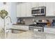 Well-appointed kitchen with granite countertops, stainless steel appliances and ample storage space at 308 Firenze Loop, Myrtle Beach, SC 29579