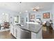 Stylish kitchen island with granite countertop, stainless steel sink and plenty of storage at 308 Firenze Loop, Myrtle Beach, SC 29579