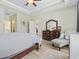 Spacious main bedroom features wood floors, neutral paint, and a dresser with mirror at 308 Firenze Loop, Myrtle Beach, SC 29579