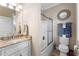 Bathroom featuring a vanity with marble countertop, framed mirror, and a shower/tub combo at 337 St. Julian Ln., Myrtle Beach, SC 29579
