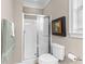 Well-lit bathroom featuring a glass door shower, toilet, and neutral decor at 337 St. Julian Ln., Myrtle Beach, SC 29579