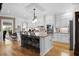 Bright kitchen features white cabinetry, stainless appliances, granite countertops, and hardwood floors at 337 St. Julian Ln., Myrtle Beach, SC 29579
