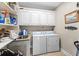 Functional laundry room with sink, storage cabinets, washer, and dryer at 337 St. Julian Ln., Myrtle Beach, SC 29579