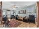Large music room with hardwood floors, multiple windows, ceiling fan, and a side door to a balcony at 337 St. Julian Ln., Myrtle Beach, SC 29579