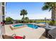 A beautifully designed pool with a hot tub and patio area, set against the backdrop of a lake at 337 St. Julian Ln., Myrtle Beach, SC 29579