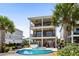A luxurious brick house featuring a private pool, hot tub, and multiple balconies with views at 337 St. Julian Ln., Myrtle Beach, SC 29579
