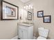 Elegant powder room with granite countertop, modern faucet, and decorative artwork at 337 St. Julian Ln., Myrtle Beach, SC 29579