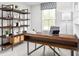 Home office is styled with dark wood desk and shelving, a patterned blind, and lots of natural light at 343 Myrtle Meadows Dr # 407C, Conway, SC 29526