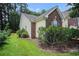 Charming exterior view showcasing brick accents, manicured landscaping, and lush greenery, enhancing curb appeal at 364 Vesta Dr., Myrtle Beach, SC 29579