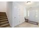Bright foyer featuring a staircase, coat closet, and a view of the front door at 364 Vesta Dr., Myrtle Beach, SC 29579