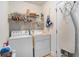 Bright laundry room featuring a washer, dryer, wire shelving, and ironing board for convenient chores at 364 Vesta Dr., Myrtle Beach, SC 29579