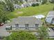Aerial view of condo community with swimming pool and lush green spaces at 3700 Golf Colony Lane # 26A, Little River, SC 29566