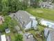 An aerial view shows condos with a pool, mature landscaping, and ample parking at 3700 Golf Colony Lane # 26A, Little River, SC 29566