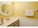 Bright bathroom featuring a sink vanity and a round mirror at 3700 Golf Colony Lane # 26A, Little River, SC 29566