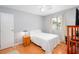 Bright bedroom with wood floors, white bedding, and natural light at 3700 Golf Colony Lane # 26A, Little River, SC 29566