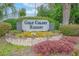 View of community sign surrounded by garden at 3700 Golf Colony Lane # 26A, Little River, SC 29566