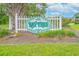 View of community sign with green landscaping at 3700 Golf Colony Lane # 26A, Little River, SC 29566