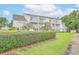 The condos feature multiple balconies surrounded by a well-manicured lawn and mature trees at 3700 Golf Colony Lane # 26A, Little River, SC 29566