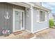 Inviting front entrance featuring nautical decor, white trim, and a secure storm door at 3700 Golf Colony Lane # 26A, Little River, SC 29566