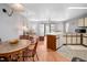 Cozy living room adjacent to the kitchen, featuring a dining table and sliding glass doors at 3700 Golf Colony Lane # 26A, Little River, SC 29566