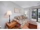 Comfortable living room with floral sofa, end tables, and sliding glass doors to the patio at 3700 Golf Colony Lane # 26A, Little River, SC 29566