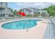 Condo building features a community pool surrounded by lush landscaping and a relaxing lounge area at 3700 Golf Colony Lane # 26A, Little River, SC 29566