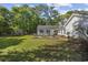 Expansive backyard with a wooden deck ideal for outdoor seating and surrounded by lush greenery at 3772 Brown Bark Ln., Murrells Inlet, SC 29576