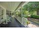 Relaxing covered porch with comfortable rocking chairs and a scenic view of the lush surroundings at 3772 Brown Bark Ln., Murrells Inlet, SC 29576