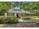 Charming home exterior featuring a welcoming porch, beautiful landscaping, and American flag decor at 3772 Brown Bark Ln., Murrells Inlet, SC 29576