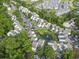 A condo community features mature trees, landscaping, on-site parking, and a serene pond with fountain feature at 4344 Spa Dr. # 605, Little River, SC 29566