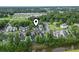 Aerial view of a condo complex with mature trees, lush landscaping and proximity to nearby amenities at 4344 Spa Dr. # 605, Little River, SC 29566