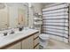 The functional bathroom features a vanity with storage, a toilet, and a shower-tub combination with shower curtain at 4344 Spa Dr. # 605, Little River, SC 29566